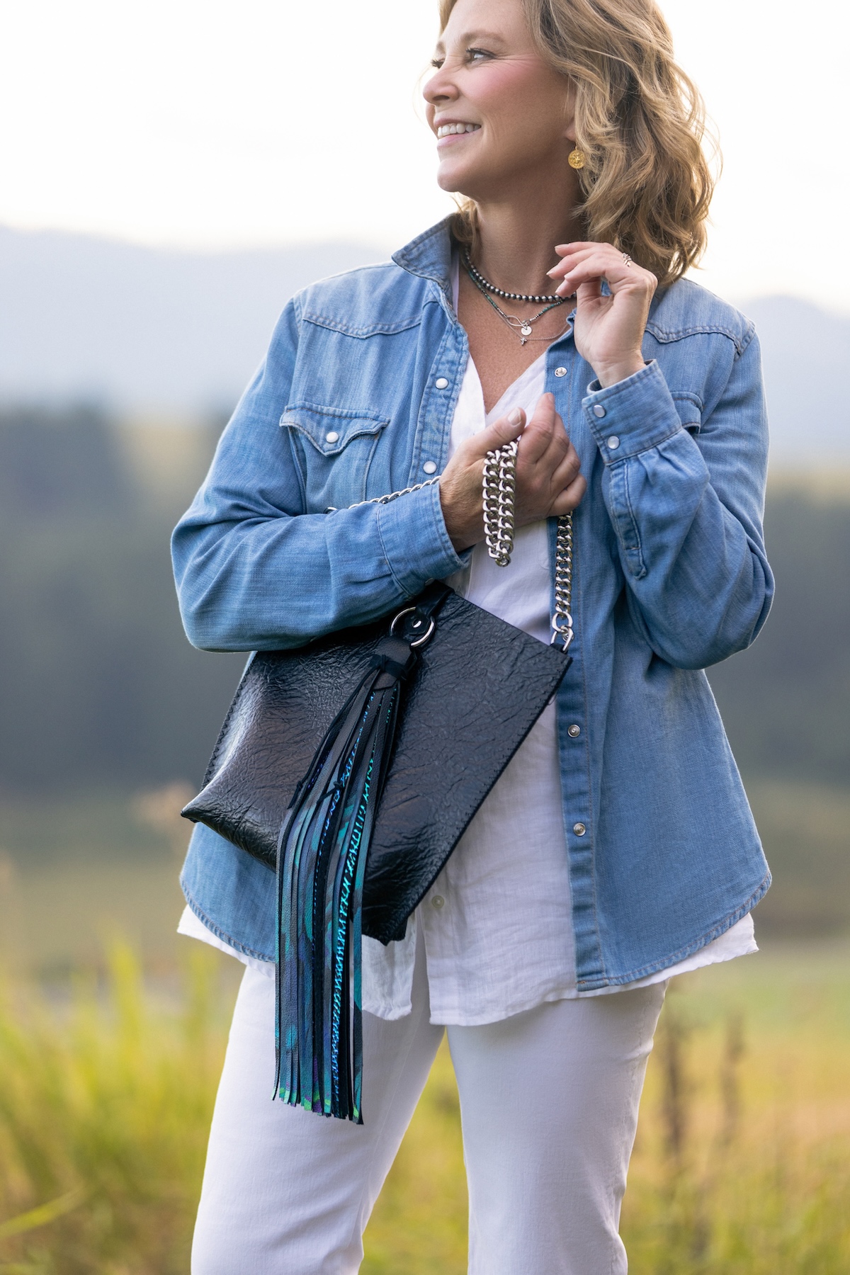 Black crossbody bag with hand painted tassel and silver chain